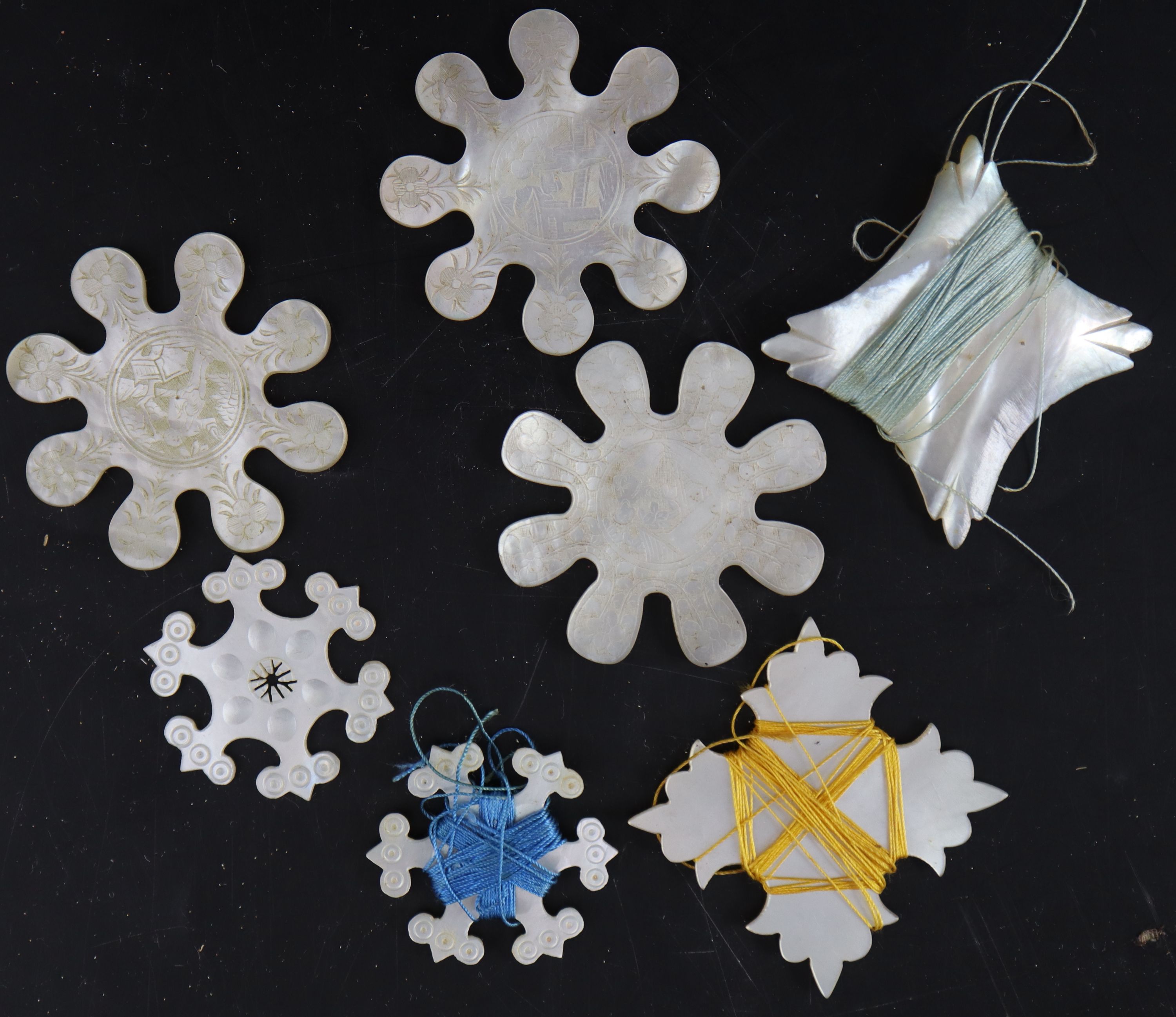 Eighteen assorted early to mid 19th century silk winders largest 9cm